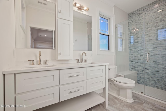 bathroom featuring an enclosed shower, vanity, toilet, and crown molding