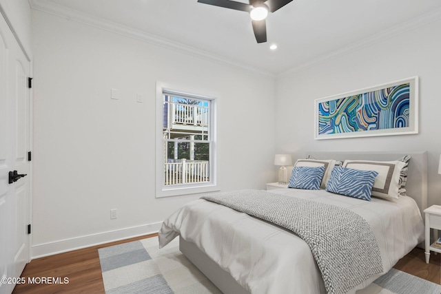 bedroom featuring ceiling fan, wood-type flooring, and ornamental molding