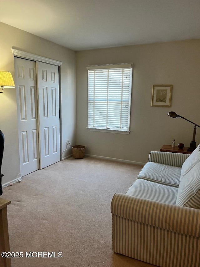 sitting room featuring light colored carpet