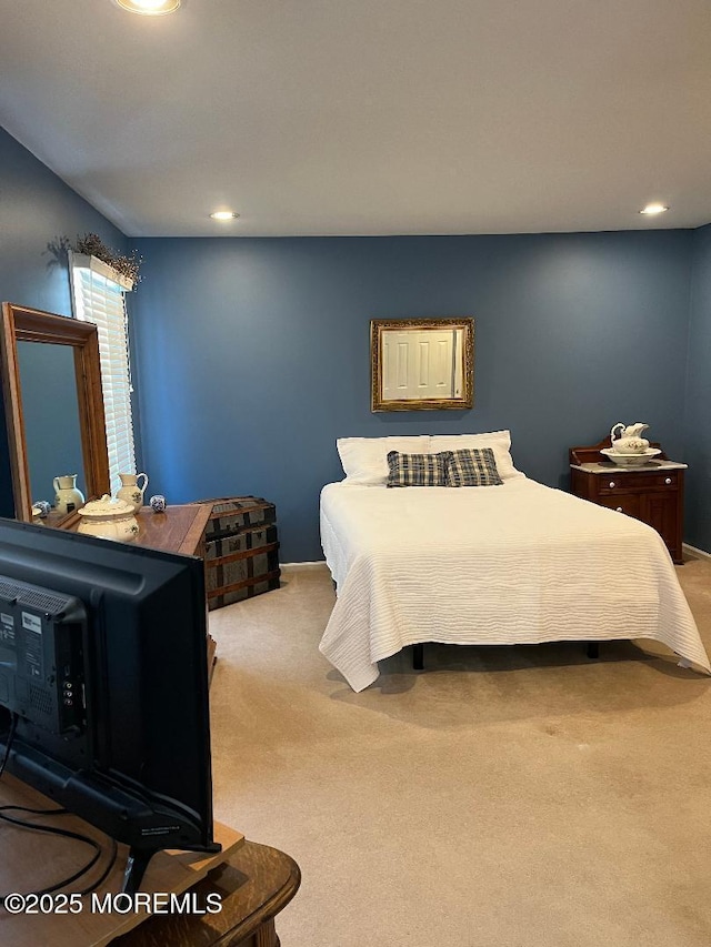 bedroom featuring light carpet