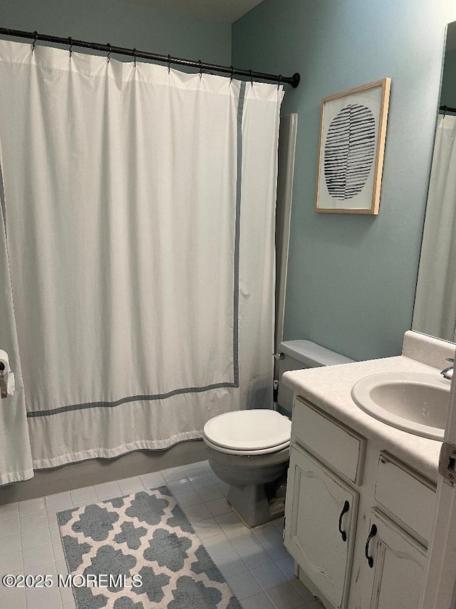 full bathroom with shower / bath combo with shower curtain, tile patterned flooring, vanity, and toilet