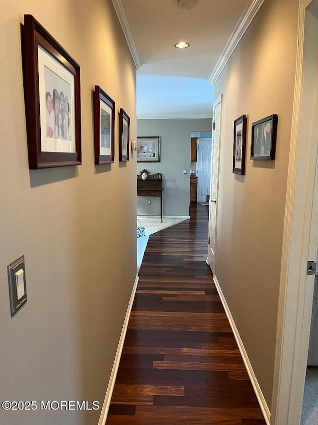 corridor with dark hardwood / wood-style floors and ornamental molding