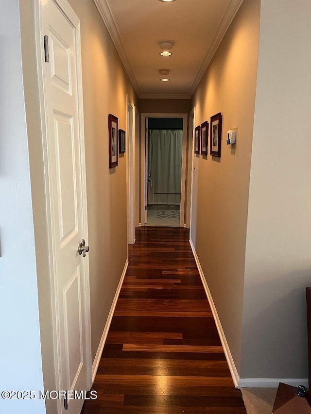 corridor featuring dark hardwood / wood-style flooring and ornamental molding