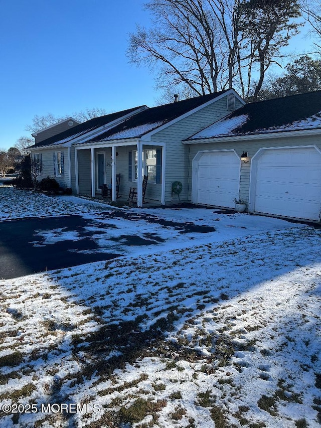 view of front of property with a porch and a garage