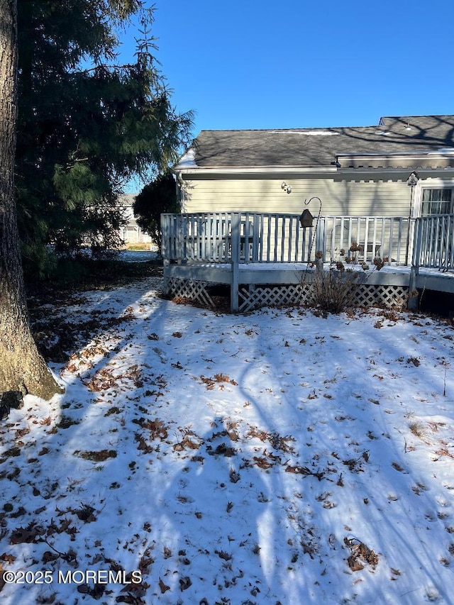 view of snowy exterior featuring a wooden deck