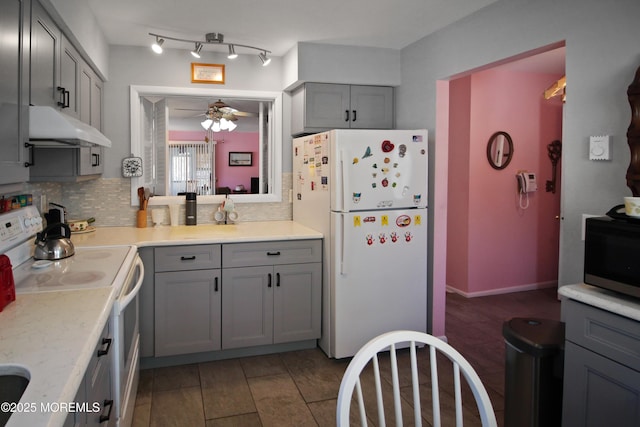 kitchen featuring white appliances, tasteful backsplash, gray cabinets, and ceiling fan