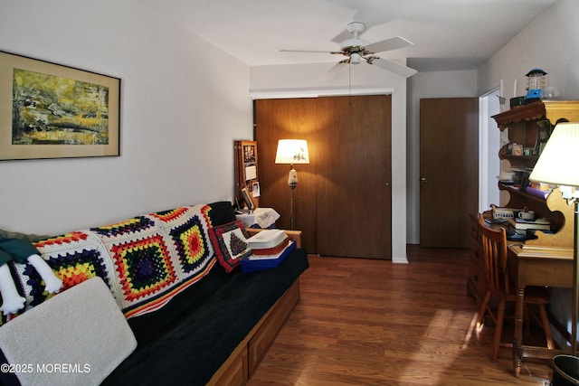 living room featuring dark hardwood / wood-style floors and ceiling fan