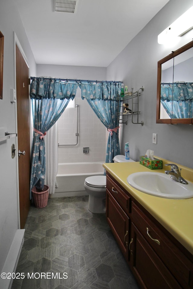 full bathroom featuring shower / bath combination with curtain, vanity, and toilet