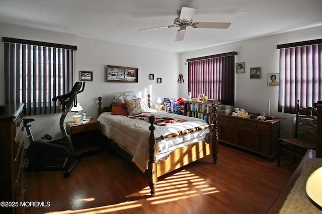 bedroom with ceiling fan and dark hardwood / wood-style floors