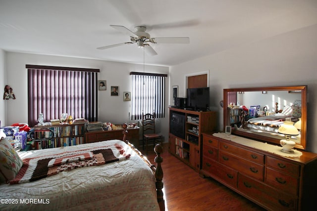 bedroom with ceiling fan and dark wood-type flooring