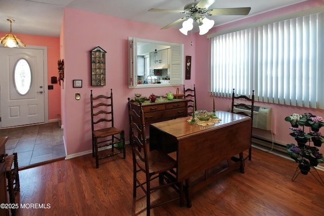 dining room featuring dark hardwood / wood-style floors, a wall unit AC, and ceiling fan