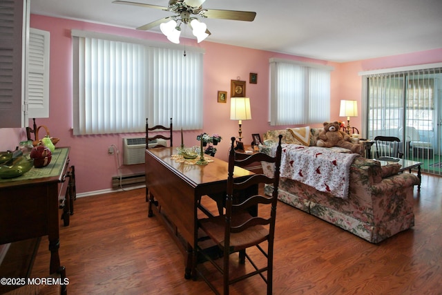 bedroom with a wall mounted air conditioner, ceiling fan, dark wood-type flooring, and a baseboard radiator