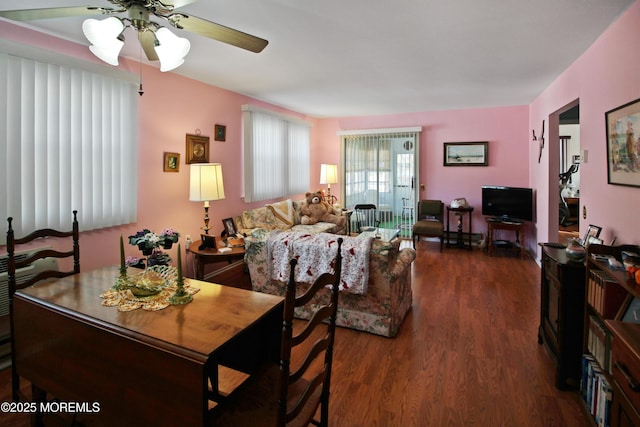 living room featuring ceiling fan and dark wood-type flooring