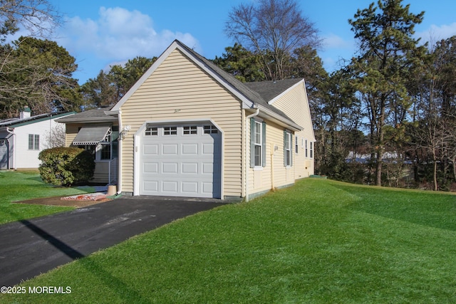 view of home's exterior featuring a yard and a garage