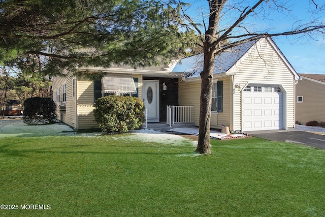 ranch-style house featuring a garage and a front lawn