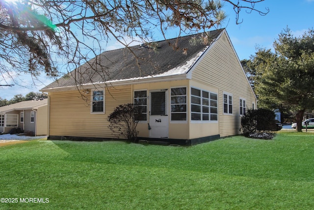 view of side of property with a lawn