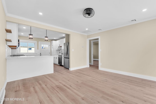 kitchen with kitchen peninsula, decorative light fixtures, light wood-type flooring, white cabinetry, and appliances with stainless steel finishes