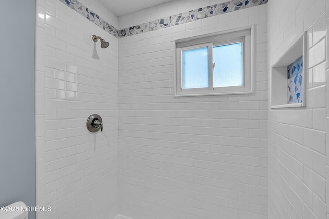 bathroom with tiled shower