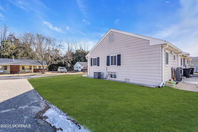 view of home's exterior featuring central AC and a lawn