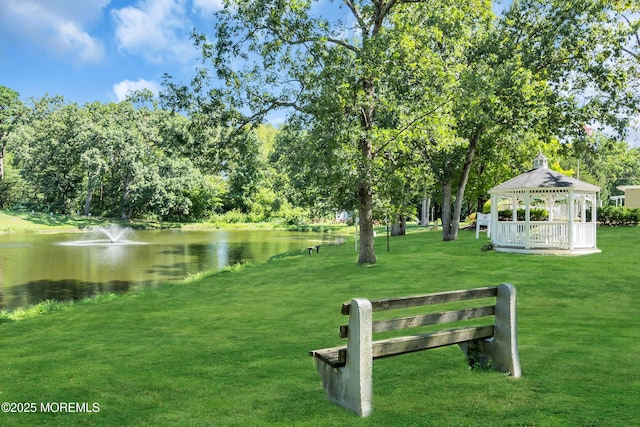 view of property's community featuring a gazebo, a yard, and a water view