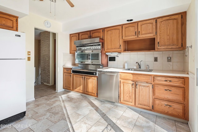 kitchen with backsplash, ceiling fan, sink, white refrigerator, and dishwasher