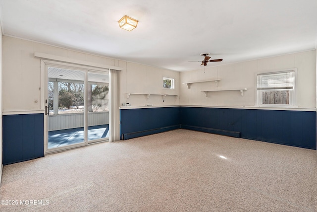 unfurnished room with carpet, plenty of natural light, and ceiling fan