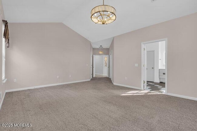 spare room with a notable chandelier, carpet floors, and lofted ceiling