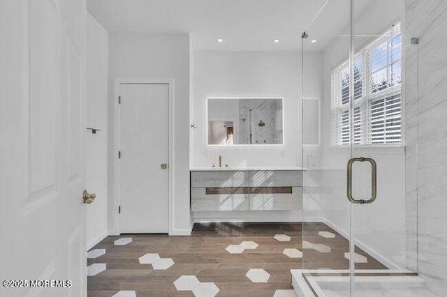 bathroom featuring vanity, hardwood / wood-style floors, and an enclosed shower