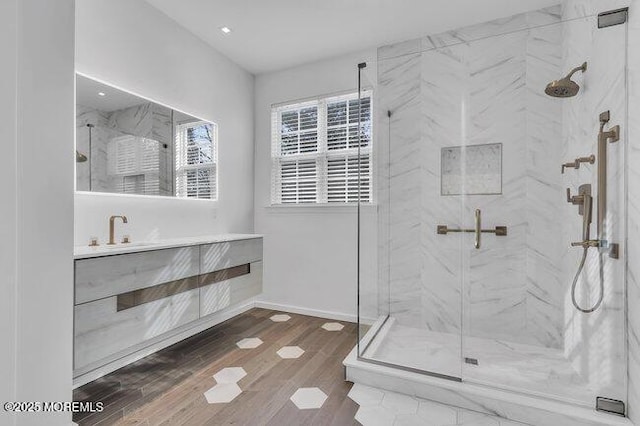 bathroom featuring vanity, walk in shower, and wood-type flooring