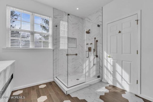 bathroom featuring hardwood / wood-style flooring and an enclosed shower