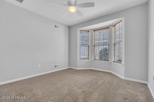 empty room featuring ceiling fan and carpet flooring