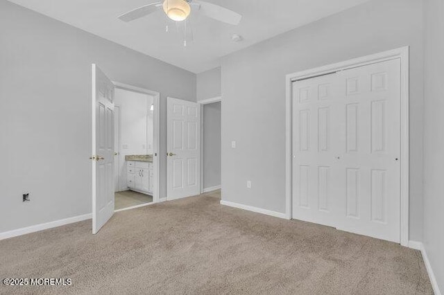 unfurnished bedroom featuring light colored carpet, a closet, and ceiling fan