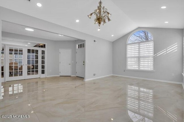 interior space featuring french doors, an inviting chandelier, and lofted ceiling