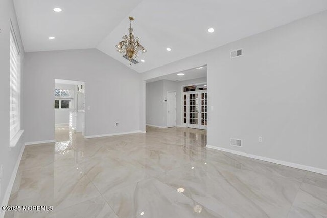 unfurnished living room featuring an inviting chandelier and lofted ceiling