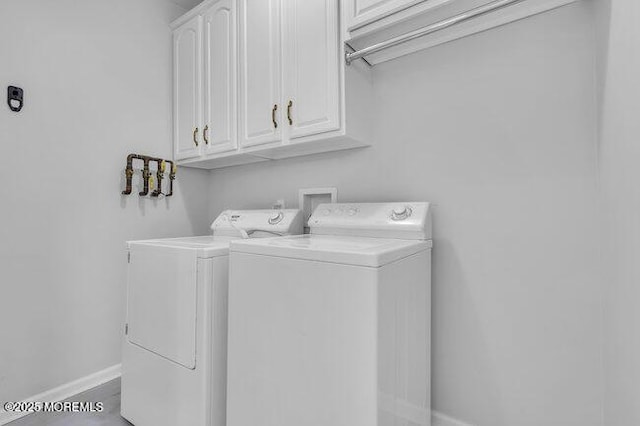 laundry area featuring washer and dryer and cabinets