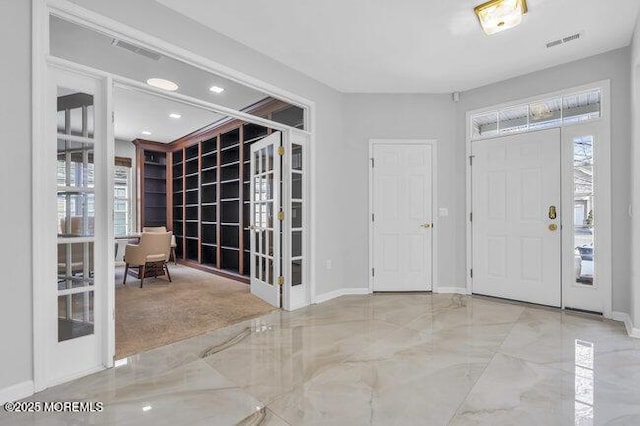 foyer with plenty of natural light and french doors