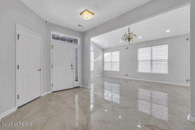 entryway featuring an inviting chandelier