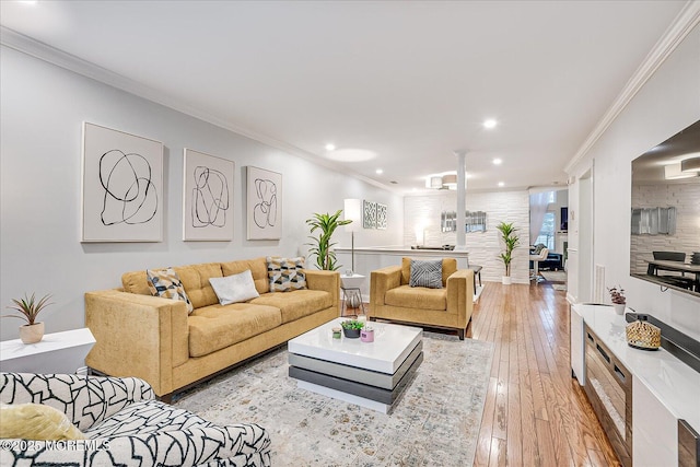 living room with light hardwood / wood-style floors and crown molding