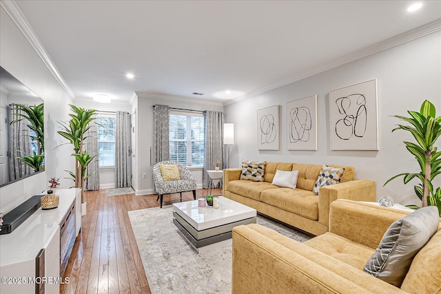 living room with light hardwood / wood-style floors and crown molding