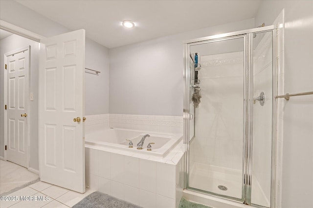 bathroom with tile patterned floors and shower with separate bathtub