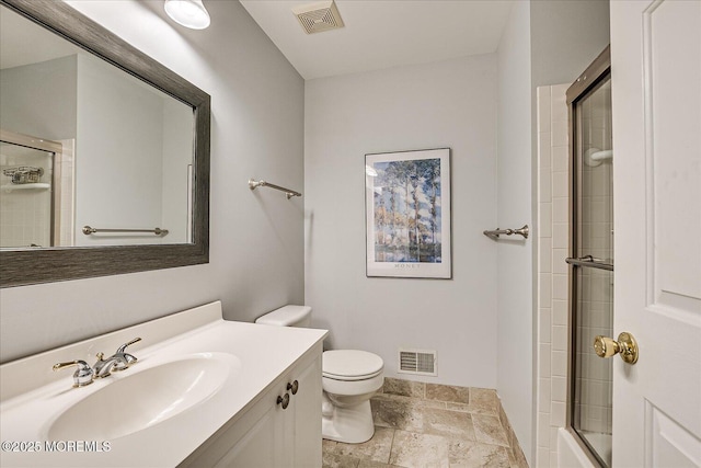 bathroom featuring vanity, toilet, and walk in shower