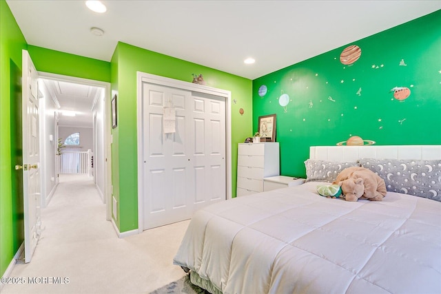 bedroom with light colored carpet and a closet