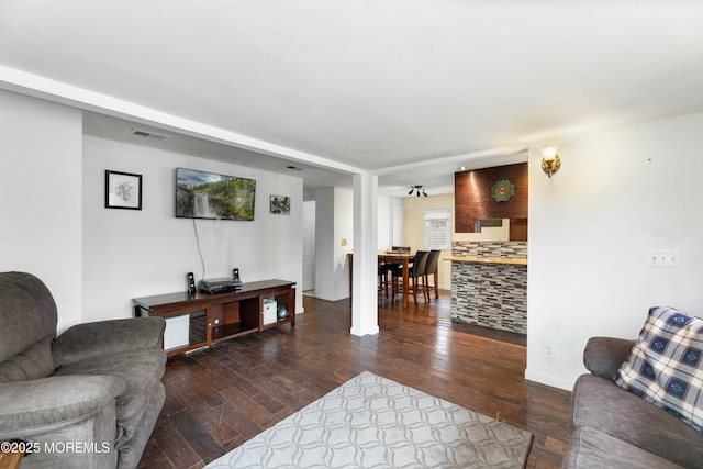 living room featuring dark wood-type flooring