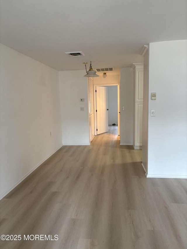 empty room with light hardwood / wood-style floors