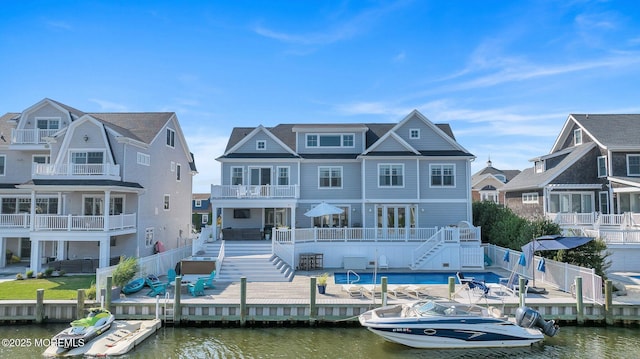 back of property featuring a deck with water view