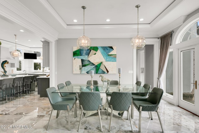 dining space featuring crown molding, a wealth of natural light, and a tray ceiling