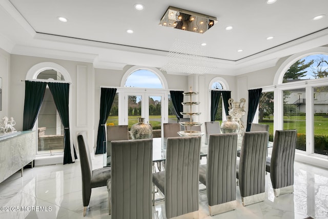 dining space featuring french doors, a tray ceiling, crown molding, and a notable chandelier