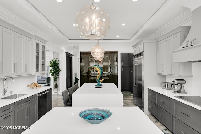 kitchen featuring sink, a tray ceiling, gray cabinets, black appliances, and custom exhaust hood