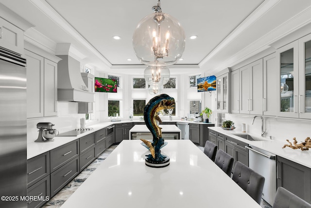 kitchen with gray cabinets, a kitchen bar, and sink