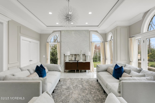 living room featuring ornamental molding and a chandelier